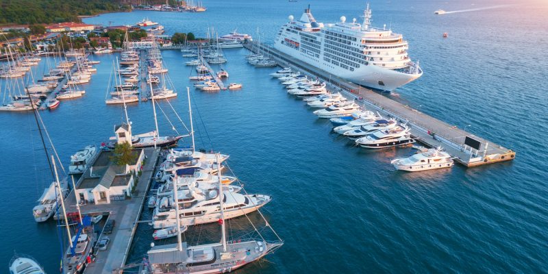 Aerial view of beautiful large white ship at sunset