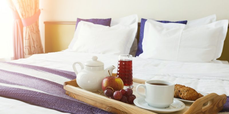 Breakfast served in bed on wooden tray