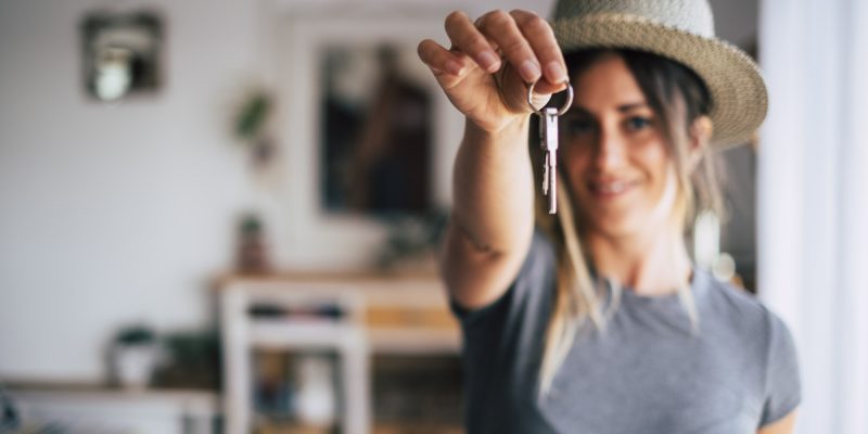 Crop close up of female tenant renter show praise house keys moving to first own new apartment