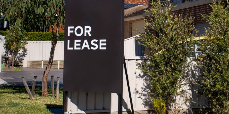 For lease sign near residential building house. Rental property. Leasing. Rent. Real estate