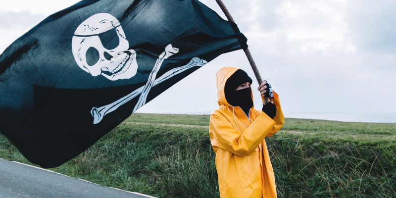 Girl with a yellow raincoat and a pirate flag.