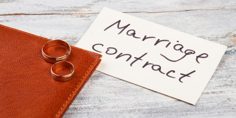 Marriage contract with wedding rings.