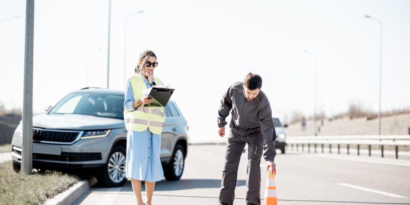 Woman and road worker during the car accident