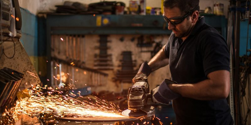 worker using an angle grinder