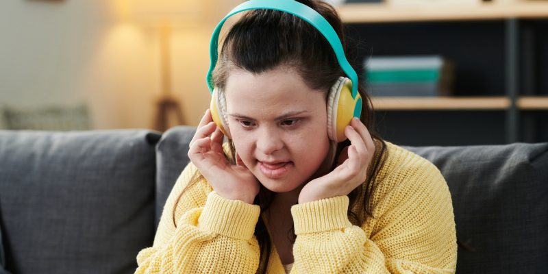 Young Woman With Disability Listening To Music